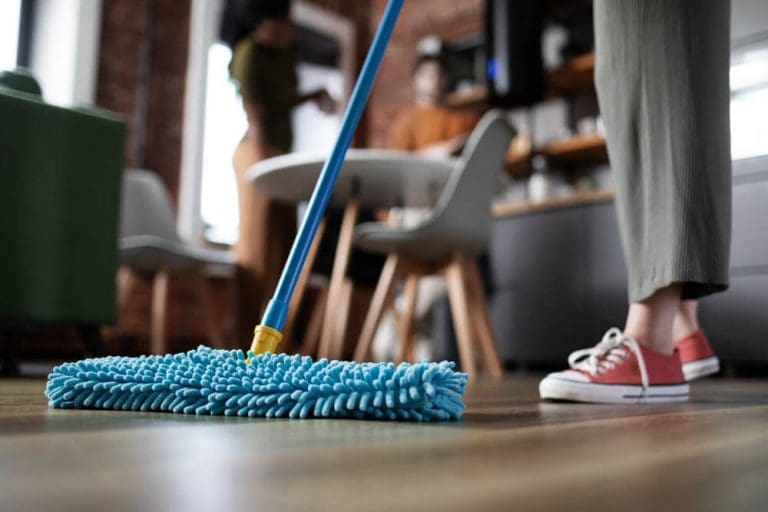 man cleaning floor with microfiber mop