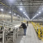 Cleaning conveyor belts in warehouse and distribution center