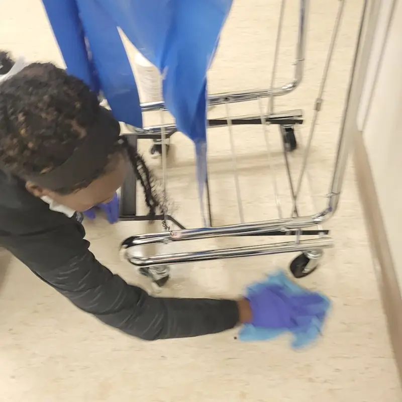 Detailed floor cleaning around waste bins in Dallas Hospital