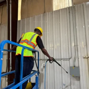 Cleaning aluminum panels and wall in warehouse facility
