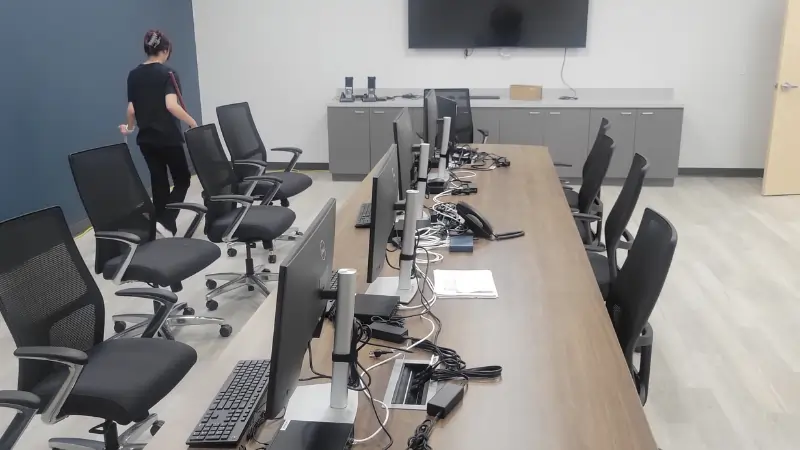 Office cleaning - cleaning floors and conference table in conference room of Cedar Hill office space