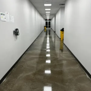 After - Post construction cleaning of 100,000 sq ft Warehouse facility in Arlington TX - completed clean and polish of concrete floor in hallway