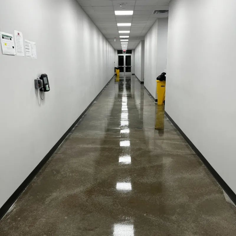 After - Post construction cleaning of 100,000 sq ft Warehouse facility in Arlington TX - completed clean and polish of concrete floor in hallway