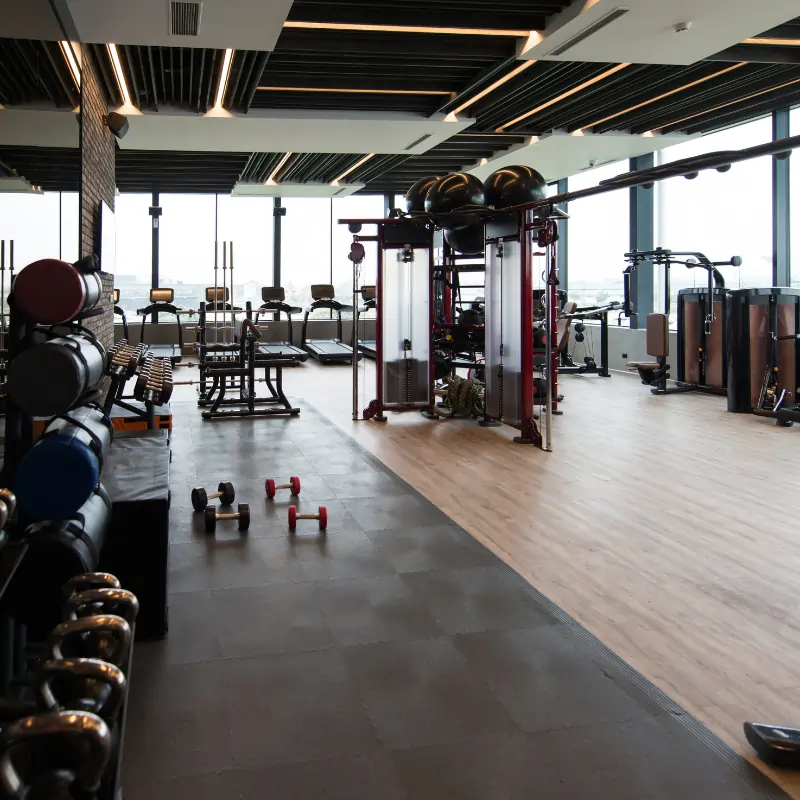 Our fitness center cleaning services include: Cleaning rubber mats, weights and nautical equipment (picture of fitness center in Dallas TX)