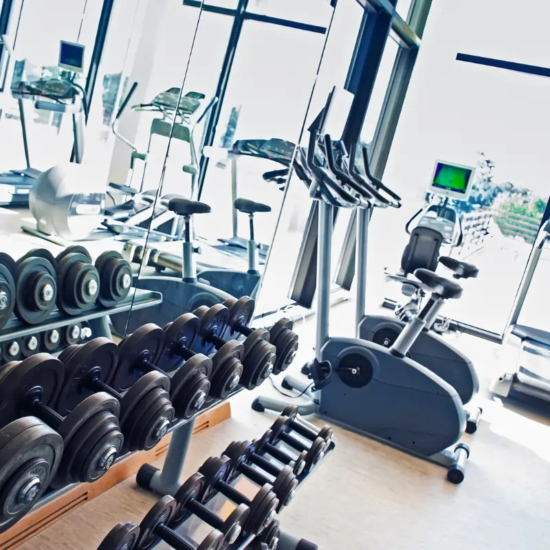 Cleaning weights and cardio machines in Fitness center in Arlington TX