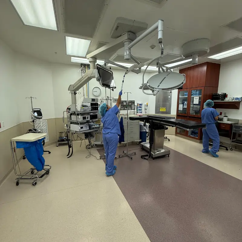 Crew cleaning treatment room in medical facility