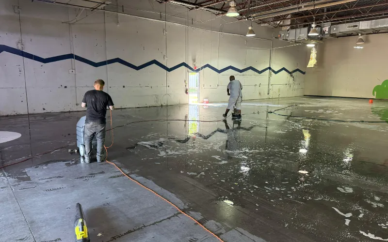 Pressure washing 110,000 sq ft concrete floors with rubber and grime residues in Dallas warehouse facility